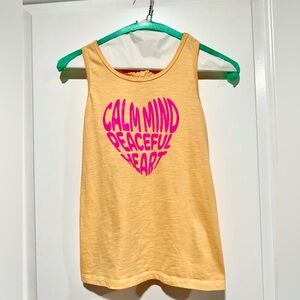 Girls loose fitting racer back, peep hole tie, graphic tank top. Size 10/12.